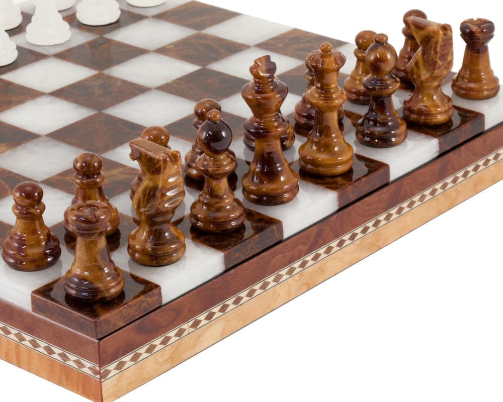 Brown and white alabaster chess set with polished chessboard and wooden inlaid cabinet, featuring intricately carved pieces.