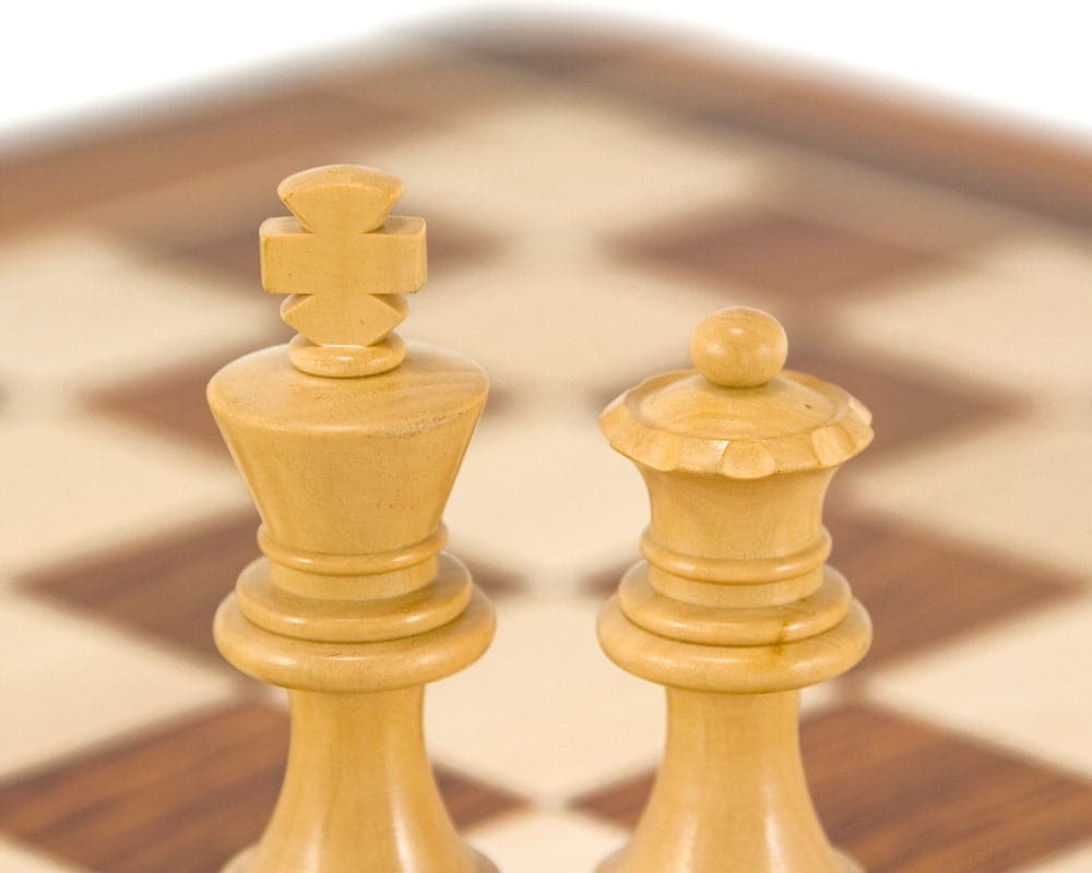 Detailed Staunton style chess pieces from the French Knight Series on a chessboard, made from golden rosewood and boxwood.