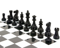 Atlantic Series Staunton chess pieces in black lacquer, polished, weighted and felted, displayed on a chessboard.