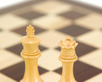 Close-up of Windsor Series Rosewood Staunton Chess king and queen pieces on a chessboard