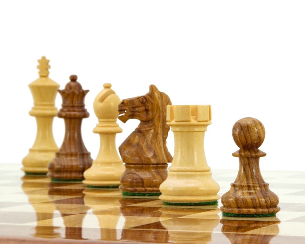 Staunton chess pieces crafted from sheesham and boxwood on a chessboard, featuring a 3-inch king and weighted design.