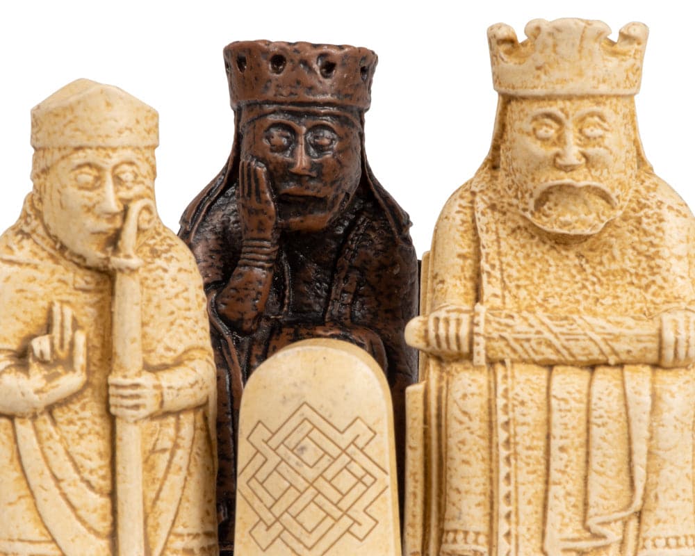 Three intricately crafted Isle of Lewis Official Chessmen pieces from the medium size 2.75-inch set, showcasing fine detailing and historical accuracy.