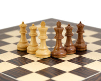 The Rochester Ebony Chessmen set on a 19 inch chess board with 1.9 inch squares, featuring beautifully crafted black and white pieces.