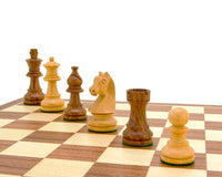 Down Head Knight Academy small chess set with Ebonized Chessmen on a walnut board displaying Staunton chess pieces and 2.5-inch king.