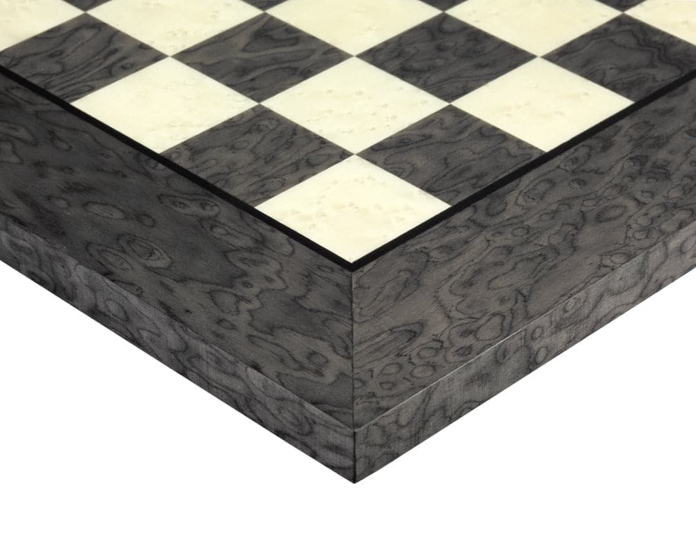 Close-up of a finely detailed black and white chessboard corner with a lacquered finish.