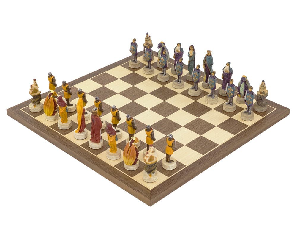 Medieval hand painted chess set on a Spanish board featuring intricate red, orange, blue, and purple pieces with exquisite detail.