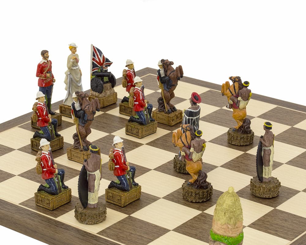 Hand-painted British Vs Zulus chess set displayed on walnut and maple board, featuring detailed figures including Zulu King Cetswayo and Lord Chelmsford.