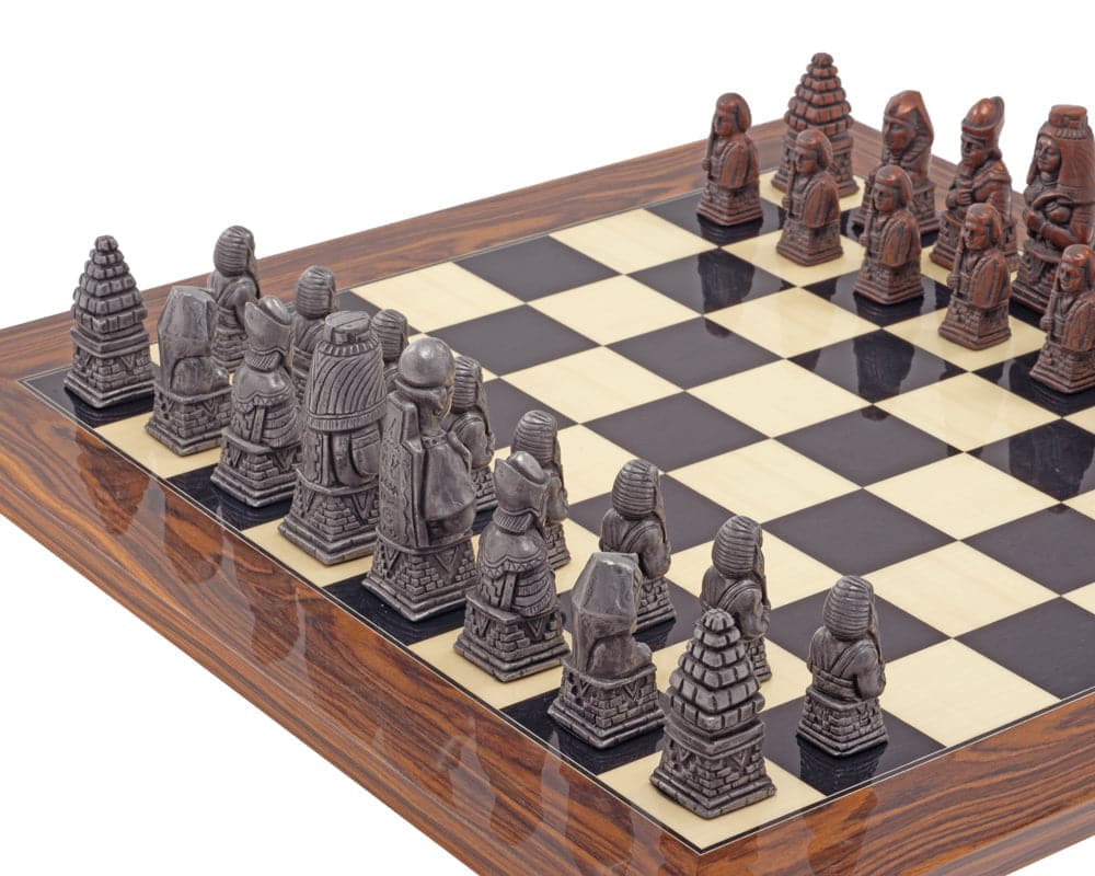 The Berkeley Chess Egyptian Metal and Palisander Chess Set featuring intricately designed pieces on a checkered board.