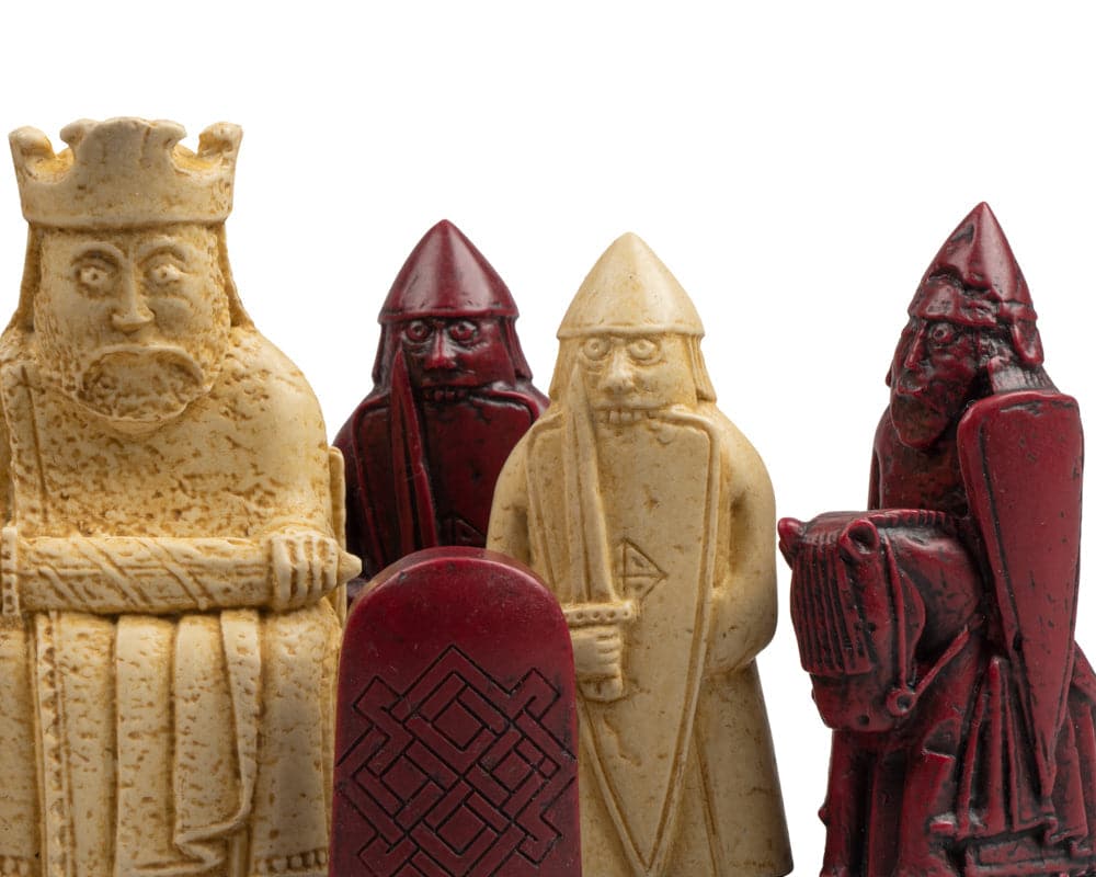 Isle of Lewis Black and Red Chess Set pieces, including a cream king and red knight, presented in gift packaging.