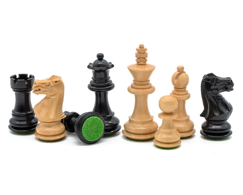 Ebony and walnut luxury chess pieces from The Kingsclere Chess Set, showcasing detailed craftsmanship and felted bases.