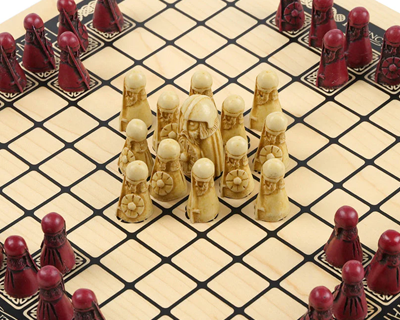 Traditional Hnefatafl board game with intricately carved pieces in a strategic arrangement.